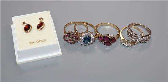 Five assorted 9ct gold gem set rings and a pair of yellow metal and garnet earrings.